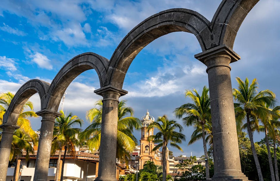 Stunning vista of Los Arcos with palm trees and sky in Puerto Vallarta, Mexico.