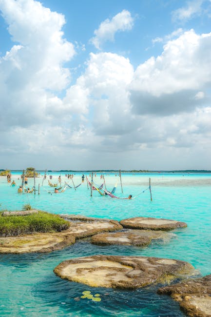 Relax in the turquoise waters of Bacalar Lagoon, Mexico, featuring hammocks and a vibrant seascape.