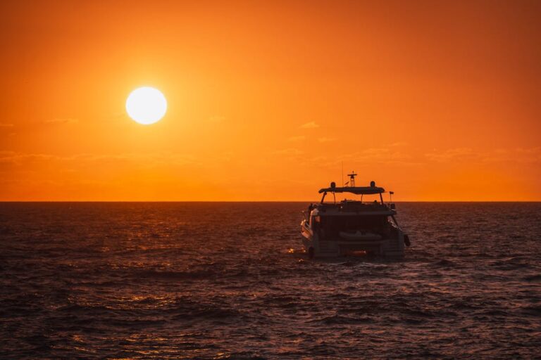 A stunning boat sails under a vivid sunset in Nuevo Vallarta, Nayarit, Mexico.
